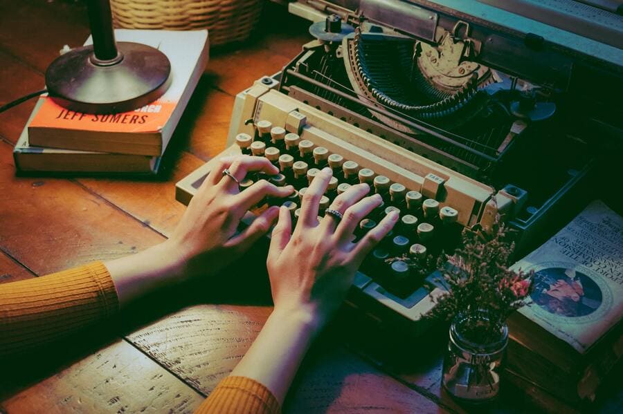 Woman's hands typing on old typewriter