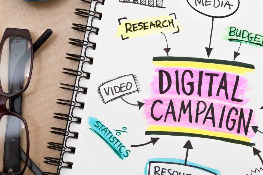 A notebook with the words "Digital Campaign" highlighted on it.