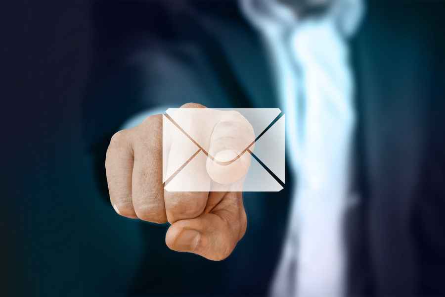 a hand pointing toward an email icon