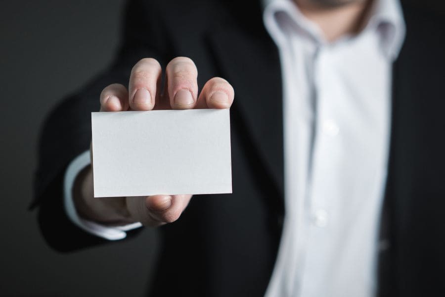 man holding blank business card