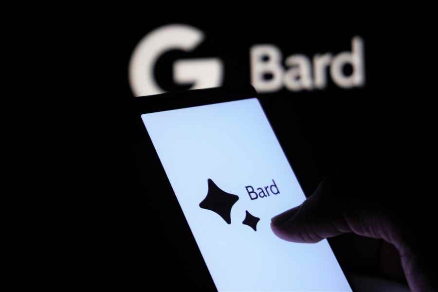 Hand holds phone with Bard logo