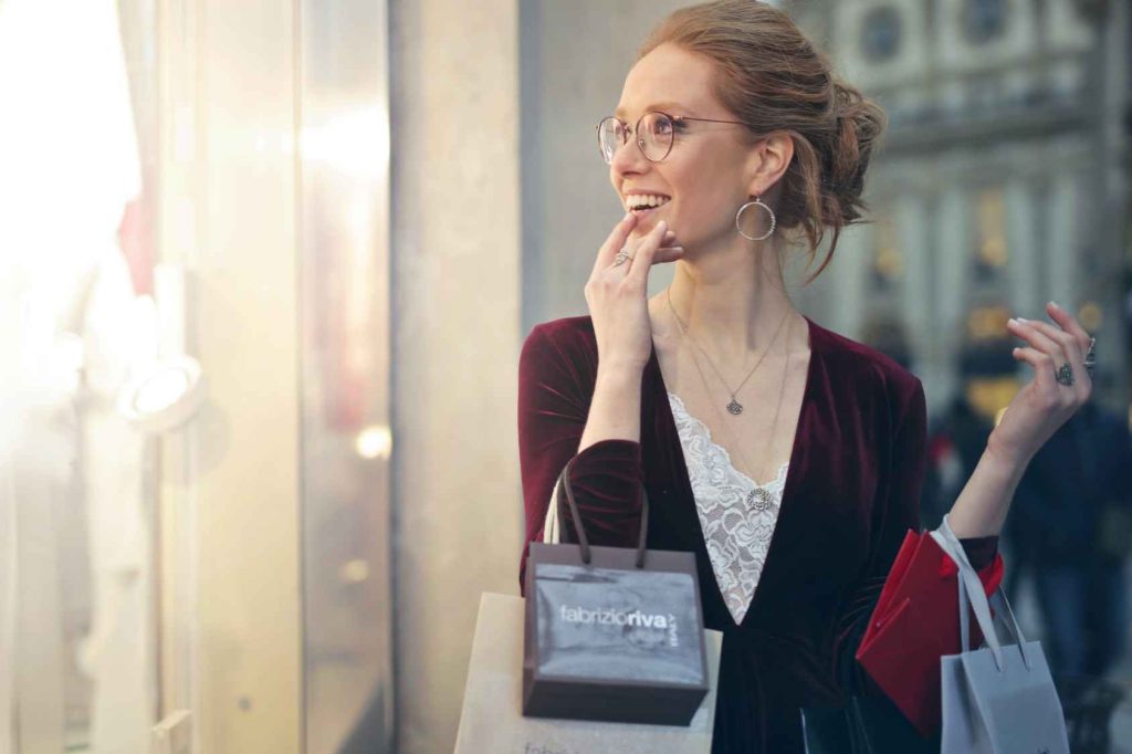 woman with shopping bags window shopping