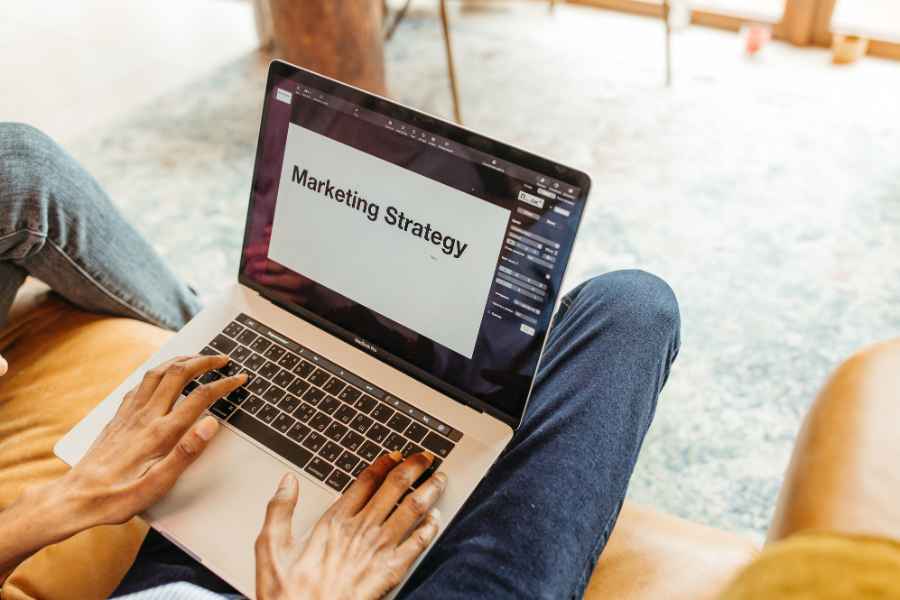 laptop screen with the words "marketing strategy"