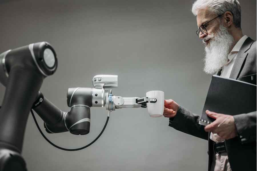 man taking coffee cup from a robot arm