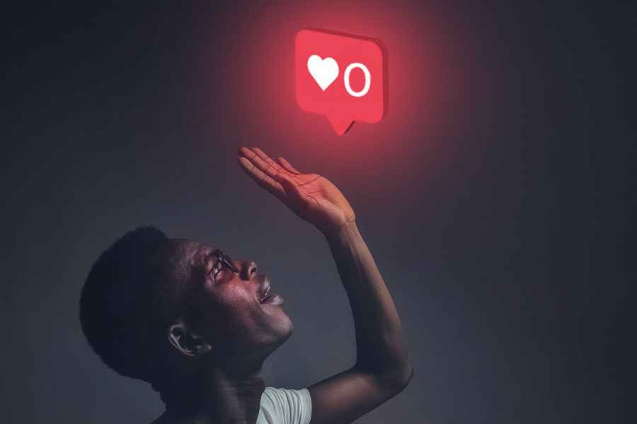 man lifting hand to an instagram heart