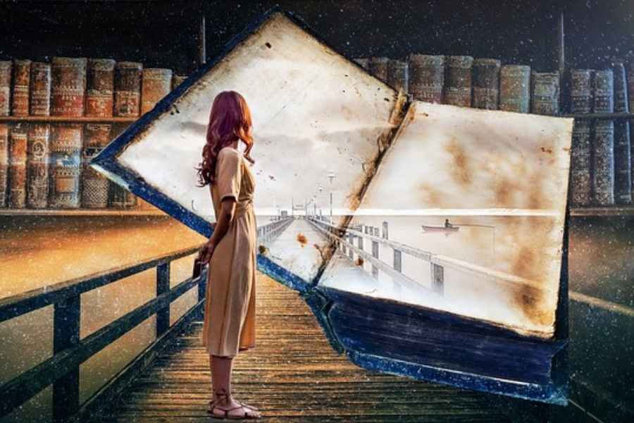 woman standing on a dock turning back to look at a book showing the same dock