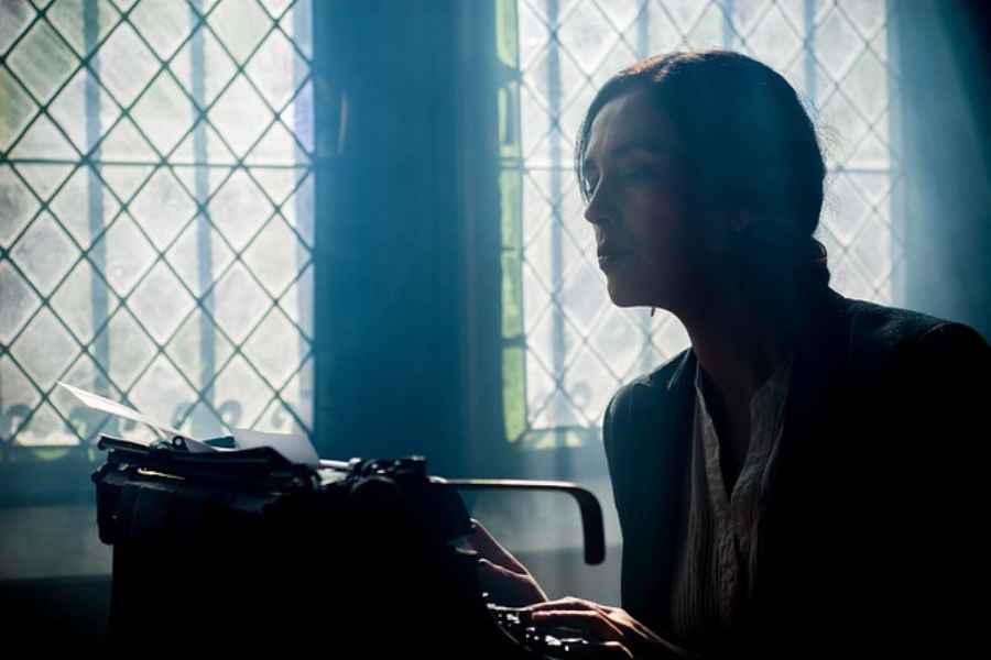 woman typing on typewriter