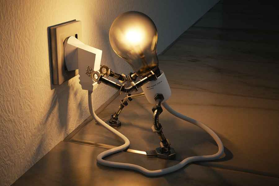 a light bulb plugging itself into a wall plug