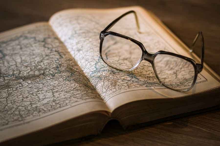 glasses on a book open to a map