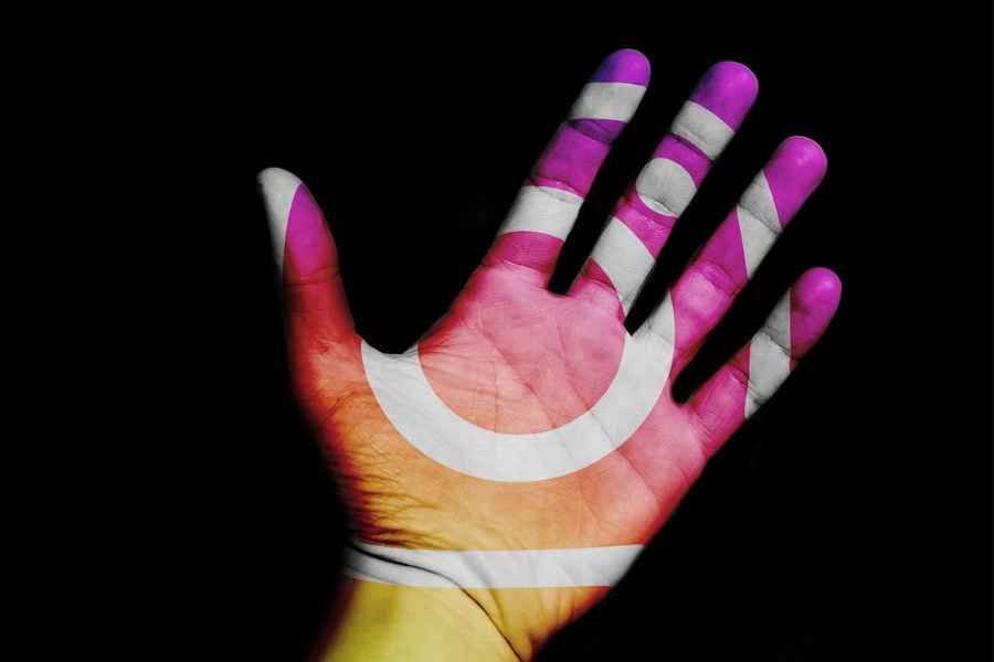an instagram color logo projected on a hand