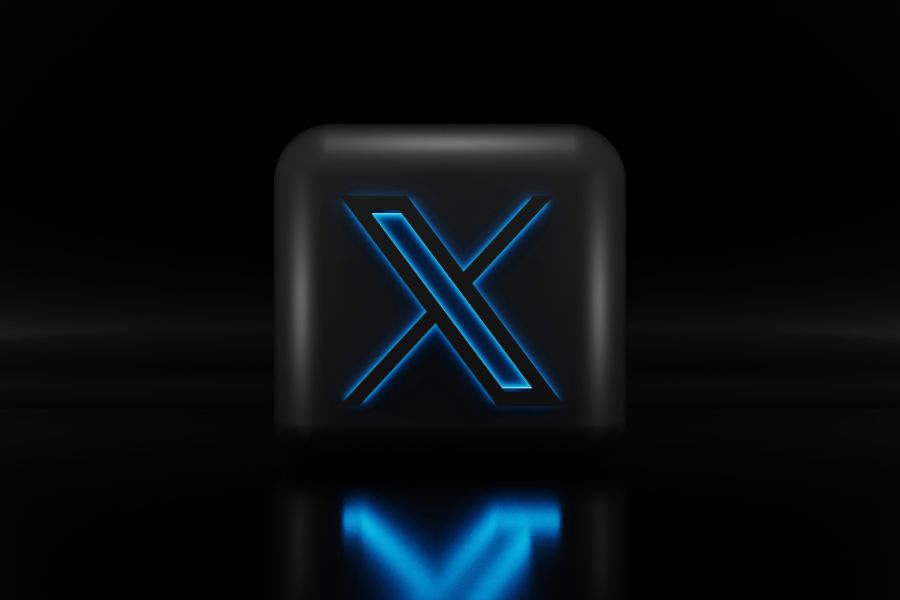 Twitter X logo on black block with blue light